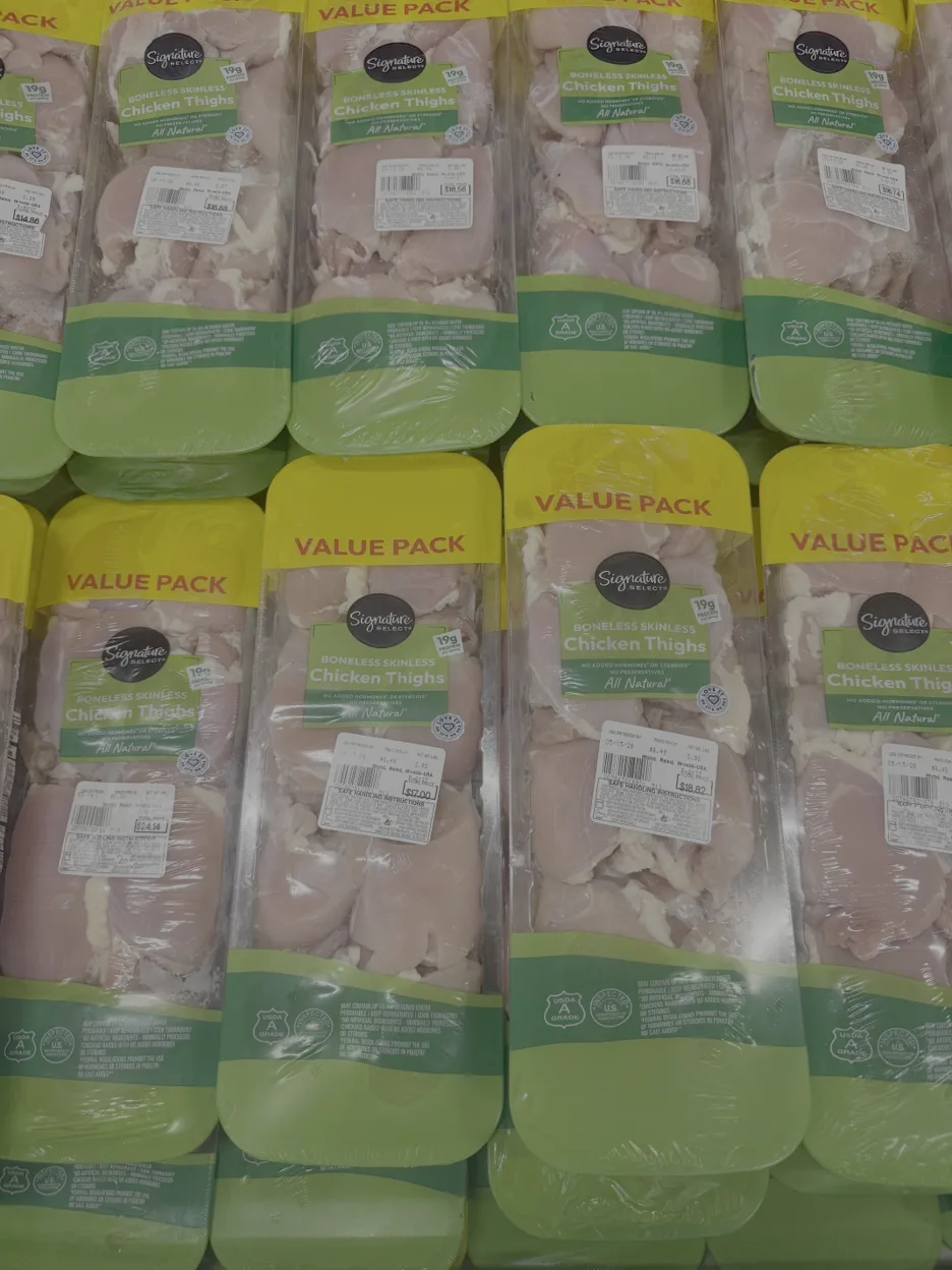 Picture13 | Axxcess Platform Rows of Signature Select boneless skinless chicken thighs in yellow 'Value Pack' labels on a supermarket shelf.